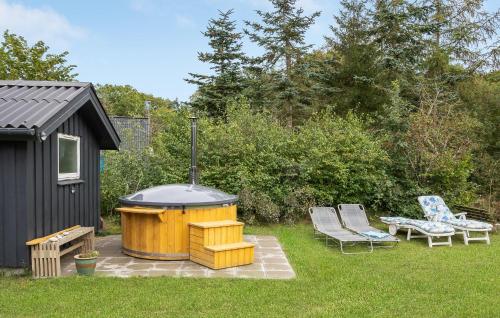 a backyard with a hot tub and a grill at Cozy Home In Glesborg With Wifi in Glesborg