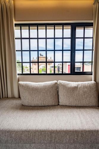 a couch sitting in front of a large window at Hotel Boutique Divino Sol in León
