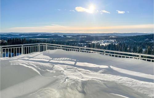 a snow covered mountain with the sun in the background at Cozy Apartment In Lillehammer With Wifi in Lillehammer