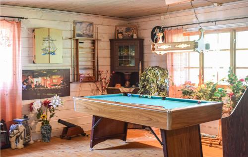 a room with a pool table in it at Cozy Home In Holmsjö With Kitchen in Holmsjö