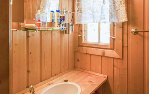 a small bathroom with a sink and a window at 3 Bedroom Cozy Home In Heggenes in Heggenes