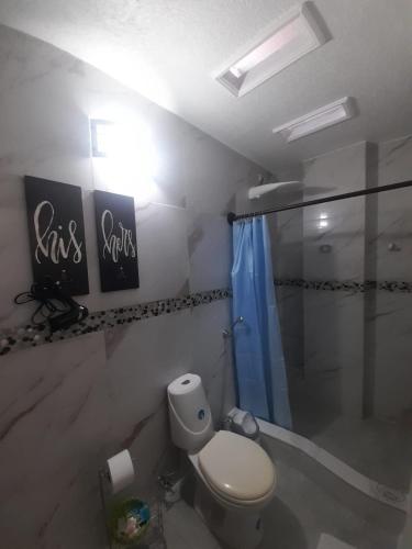a bathroom with a toilet and a shower at Hostal Cann's House in Puerto Baquerizo Moreno