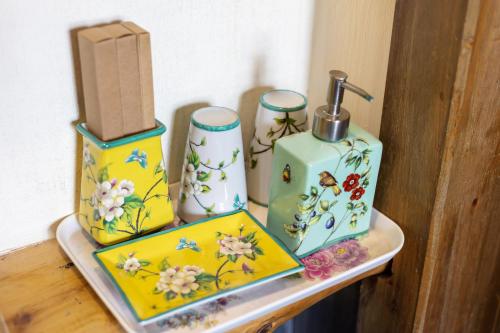 a table with three vases and a box on it at Butterfly Flowers Inn in Zhangjiajie