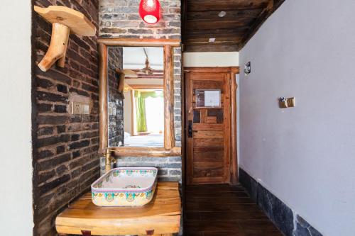 a room with a suitcase sitting on a wooden floor at Butterfly Flowers Inn in Zhangjiajie