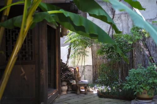 an entrance to a garden with plants and a fence at Butterfly Flowers Inn in Zhangjiajie