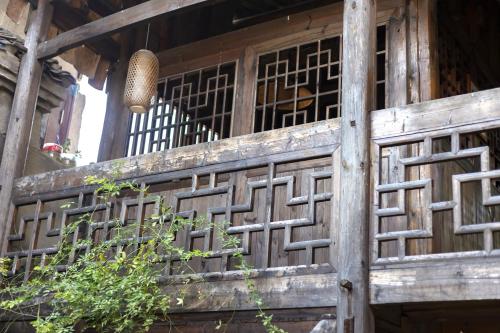 an entrance to a wooden building with a window at Butterfly Flowers Inn in Zhangjiajie