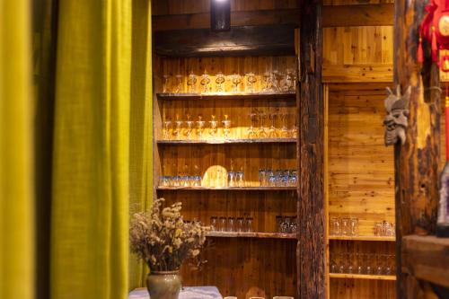 a room with a shelf filled with glasses at Butterfly Flowers Inn in Zhangjiajie