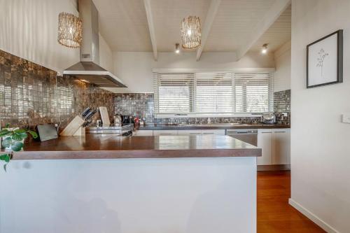 a kitchen with a sink and a counter top at Port Philip Panorama - Bayview Retreat and Pool Bliss in Mount Martha