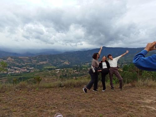 a group of people standing on top of a hill at Cabaña Cueva del Zorro in Ráquira