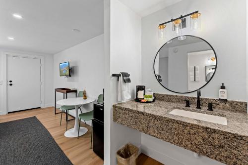 a bathroom with a sink and a mirror at Cashmere Inn in Cashmere