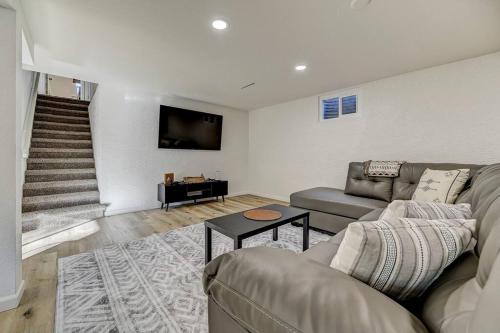 a living room with a couch and a tv at Palmer Pointe Heights Colorado Adventure Home Base WiFi, AC & Pets in Colorado Springs