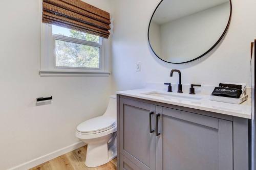 a bathroom with a toilet and a mirror at Palmer Pointe Heights Colorado Adventure Home Base WiFi, AC & Pets in Colorado Springs