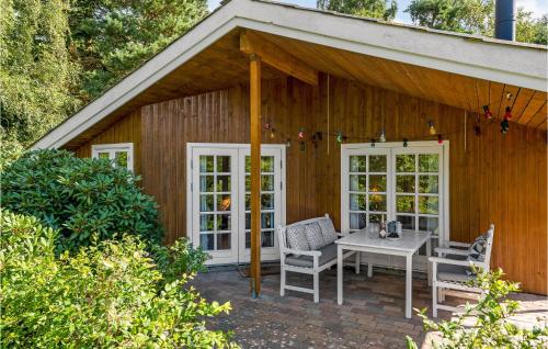 a patio with a table and chairs in front of a building at Holiday Home Højby 9 in Lumsås