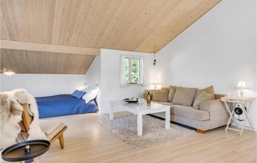 a living room with a couch and a table at Holiday Home Højby 9 in Lumsås