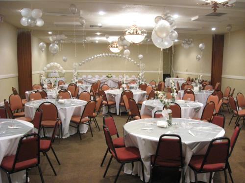 a banquet room with white tables and chairs and balloons at Country Hearth Inn & Suites Marietta in Atlanta