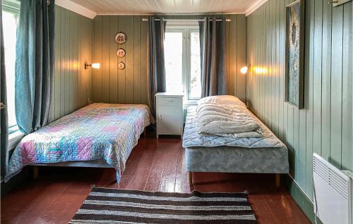 a small bedroom with two beds and a window at Pet Friendly Home In Smøla With Wifi in Smøla