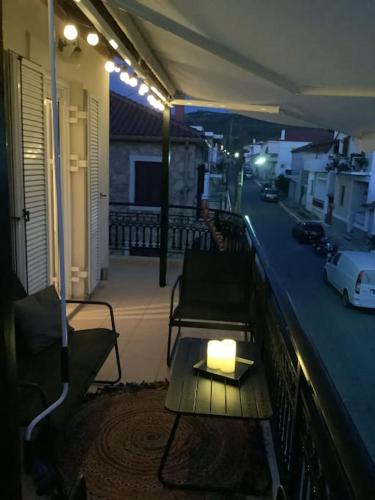 a candle on a table on a balcony at night at Lemon tree in Filiatra