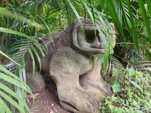 a statue in the middle of some plants at Villa Mango B&B in Nosara