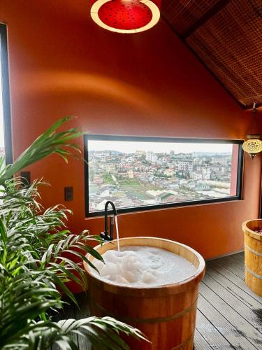 a bath tub in a room with a window at Âm Ấm Đà Lạt Boutique Hotel & Cozy Bistro in Khu Chi Lăng