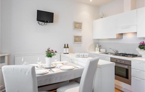 - une cuisine blanche avec une table et des placards blancs dans l'établissement Apt Braida, à Corona