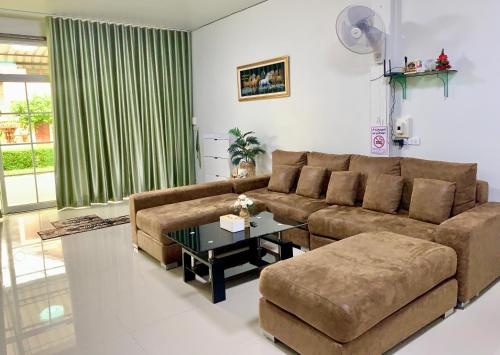 a living room with a couch and a table at BAAN OZONE HY2 in Hat Yai