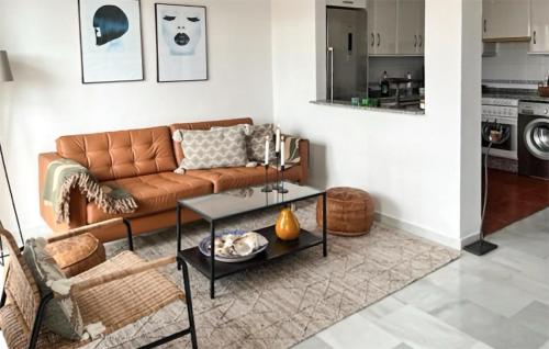 a living room with a couch and a table at 3 Bedroom Stunning Apartment In Nerja in Nerja