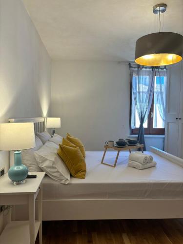 a bedroom with a large white bed with a lamp at Amas Apartment in Fondi