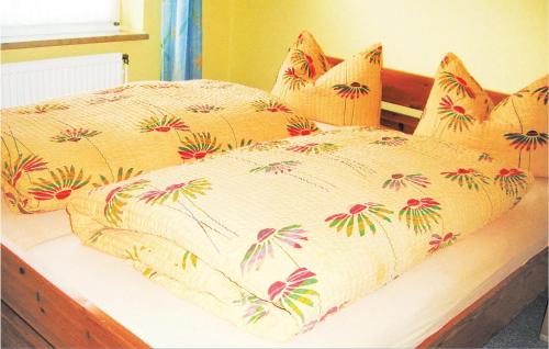 a bedroom with a bed with flowers on it at 1 Bedroom Amazing Apartment In Hohwacht in Hohwacht