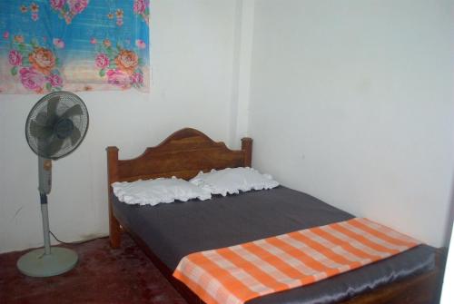 a bedroom with a bed and a fan at Meemure Rawana Adawiya in Meemure