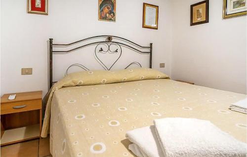 a bedroom with a bed and a wooden nightstand at 5 Bedroom Awesome Home In Noto in Noto