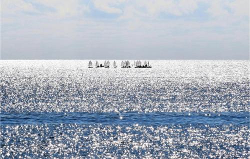a group of sailboats in the ocean on the water at 5 Bedroom Awesome Home In Noto in Noto
