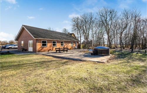 a house with a grill in front of a yard at Gorgeous Home In Grindsted With Kitchen in Grindsted