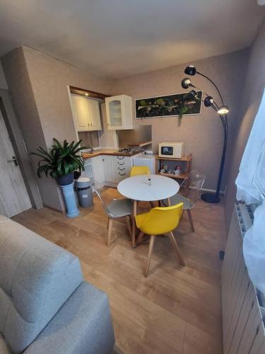 un salon avec une table et des chaises et une cuisine dans l'établissement Au ptit bonheur comtois, à Rosières-sur-Barbèche