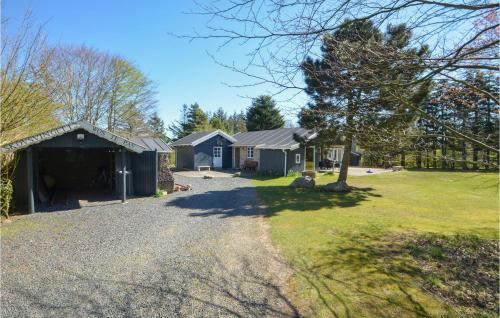 a house with a yard with a driveway at Three-Bedroom Holiday Home In Spottrup in Spottrup