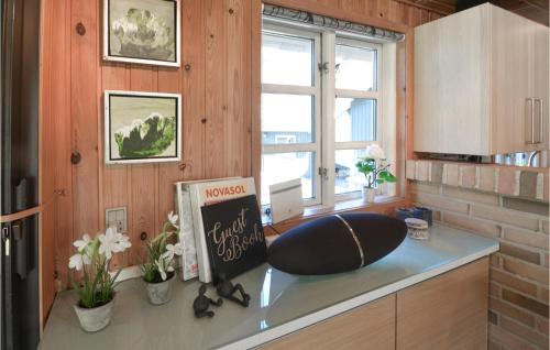 a kitchen with a counter with a chair on it at Three-Bedroom Holiday Home In Spottrup in Spottrup