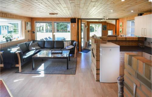 a living room with a couch and a table at Three-Bedroom Holiday Home In Spottrup in Spottrup