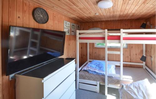 a room with two bunk beds and a flat screen tv at Three-Bedroom Holiday Home In Spottrup in Spottrup