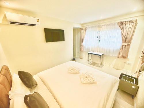 a hospital room with a bed and a window at ABC HA Hotel Bangkok in Bangkok