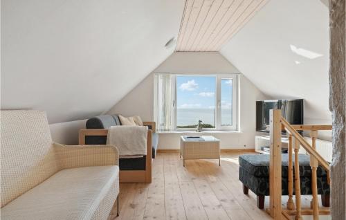 a living room with a couch and a window at Amazing Home In Vesløs in Øsløs