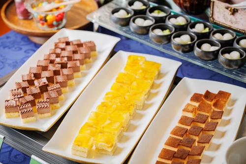 a table with three white plates of desserts at Hotel Monte Hermana Sendai in Sendai