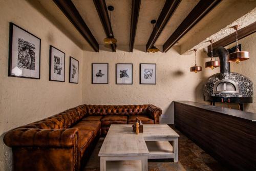 a living room with a leather couch and a table at Tree of Life Indra Mandala Hotel, Gangtok in Gangtok