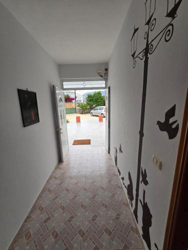 a hallway with birds on the wall of a house at Villa Papa in Ksamil