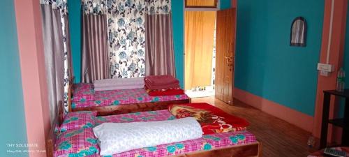 a room with two beds in a room at Sotang Homestay Ramdhura in Kalimpong