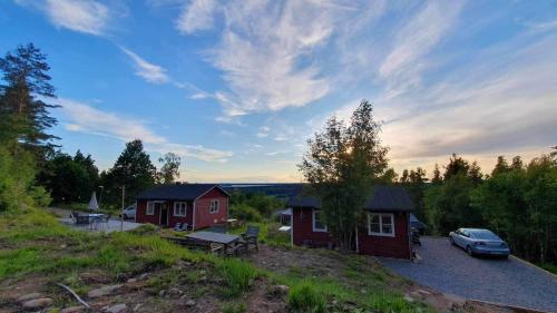 a house with a car parked in front of it at Fully renovated cottage with great hilltop views in Undenäs