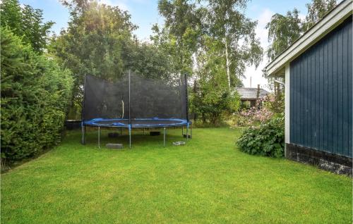 a ping pong table in the grass in a yard at Lovely Home In Juelsminde With Kitchen in Sønderby