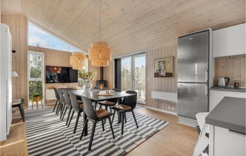 a kitchen and dining room with a table and chairs at 5 Bedroom Amazing Home In Glesborg in Glesborg
