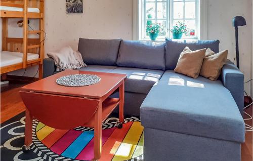 a living room with a blue couch and a table at Holiday Home Hörlösa Löttorp in Gamleby