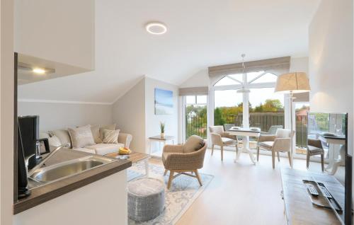 a kitchen and living room with a couch and a table at Baltischer Hof Apartment 67 in Boltenhagen