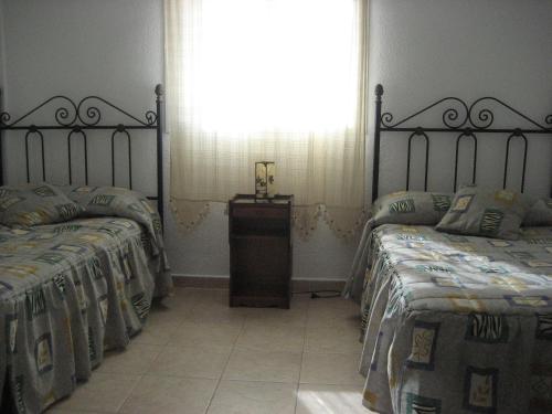 A bed or beds in a room at Residencial Augusta