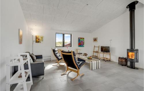 a living room with a fireplace and a stove at Holiday Home Hvide Sande 25 in Bjerregård